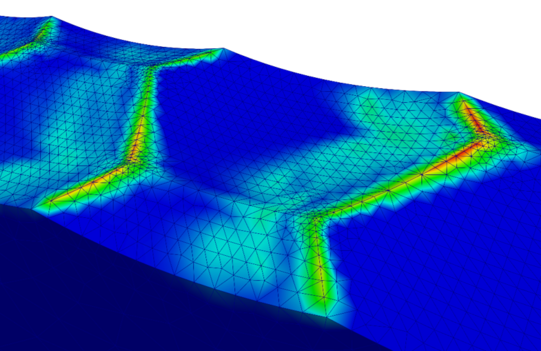 Wear evolution of the structured surface A close up few of the honey-comb surface structure with a rainbow color plot showing that especially the edges of the surface feature exhibit large wear values. Also the surfaces of the honeycomb next to the edges are colored to show that these regions are also worn. The bottom of the honeycombs seems to be unaffected by the wear progress.